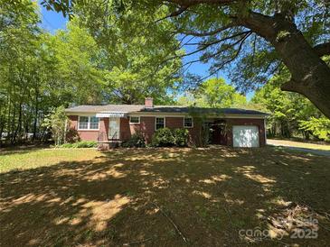 Charming brick home with attached garage and mature trees at 2703 34Th Street Ne Pl, Hickory, NC 28601