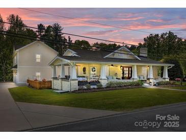 Charming home exterior with a spacious front porch, stone accents, and manicured lawn at 3008 Gantt St, Salisbury, NC 28146