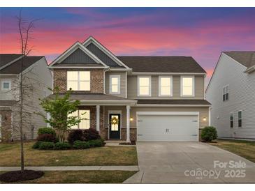 Charming two-story home featuring a two-car garage and a welcoming front porch with beautiful landscaping at 3619 Slider Ter, Lancaster, SC 29720