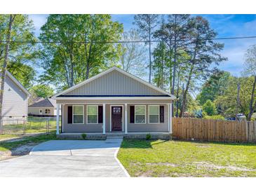 Charming single-story home featuring a well-manicured lawn and inviting covered porch area at 402 Digh St, Gastonia, NC 28052
