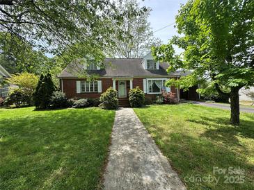 Charming brick home with a well-manicured lawn and a welcoming walkway at 404 S Mulberry St, Cherryville, NC 28021