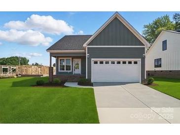 Charming single-story home with a two-car garage and well-manicured lawn at 424 Fulton Dr, Kings Mountain, NC 28086