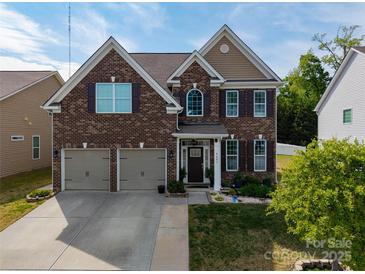 Beautiful two-story brick home featuring a two-car garage, manicured lawn, and a welcoming front porch at 4607 Bonroi Ave, Charlotte, NC 28213
