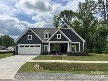 Charming new construction home featuring a well-manicured lawn and a spacious white two-car garage at 5006 Mclaughlin Dr # 103, Waxhaw, NC 28173