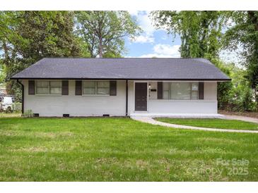 Charming home featuring a well-maintained lawn, a classic brick facade, and tasteful shutters enhancing its curb appeal at 816 Echo Glen Rd, Charlotte, NC 28213