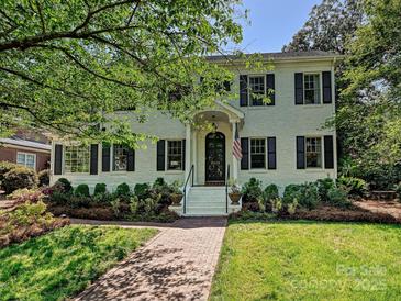 Charming two-story brick home with a landscaped front yard and inviting walkway at 2018 Radcliffe Ave, Charlotte, NC 28207