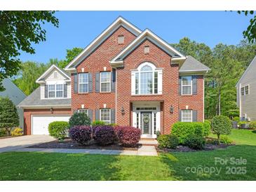 Beautiful two-story brick home with manicured lawn and lush landscaping in a desirable neighborhood at 2036 E Foxwood Ct, Indian Land, SC 29707