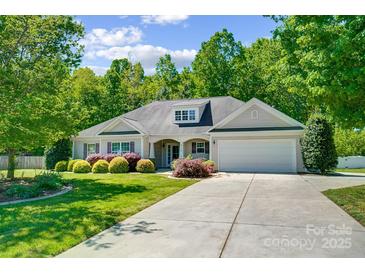 Charming single-story home with a well-maintained front yard, a two car garage, and a cozy, inviting appearance at 2113 London Ln, Belmont, NC 28012