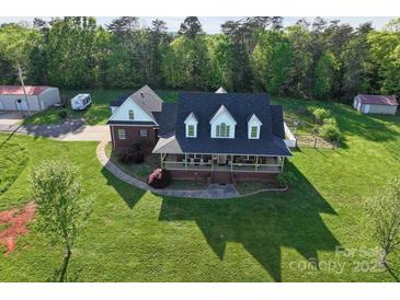 Aerial view of a charming two-story home with a well-manicured front yard and inviting front porch at 3300 Paul Heavner Ln, Lincolnton, NC 28092