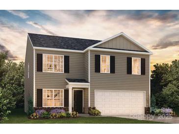 Charming two-story home featuring a welcoming entrance, a two-car garage and a beautifully landscaped front yard at 5066 Beargrass Dr, Dallas, NC 28034