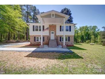 Charming two-story home featuring a welcoming entrance and a well-manicured front yard at 600 Burns St, Wadesboro, NC 28170