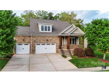 Charming two-story home with stone facade, two-car garage, covered porch and well-manicured landscaping at 1215 39Th Ne Ave, Hickory, NC 28601