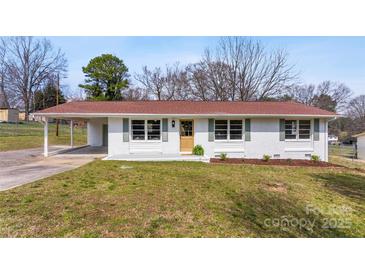 Charming single-story home with white brick, a red roof, and well-maintained lawn at 2232 Glenraven Ave, Gastonia, NC 28052
