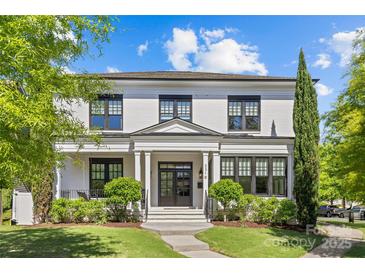 Charming white two-story home with black trim, manicured landscaping, and inviting front entrance at 2316 Westminster Pl, Charlotte, NC 28207