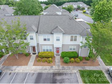 Charming townhouse with landscaped front yard, neutral siding, and gray shingle roof at 2388 Loch Stone Dr # E, Gastonia, NC 28054