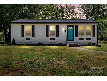 Charming home featuring a newly painted exterior, black shutters, and a vibrant turquoise front door at 2515 Danforth Ln, Charlotte, NC 28208