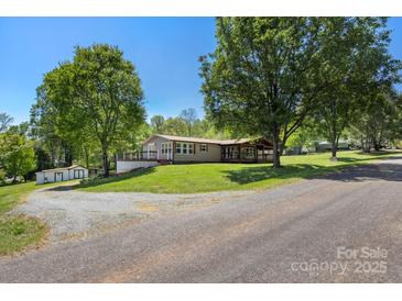 Charming single-story home with a covered front porch and lush green lawn at 2942 Denwood Dr, Claremont, NC 28610