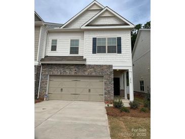 Charming two-story home featuring a stone front and attached two-car garage at 3019 Glenn Hope Way, Matthews, NC 28104