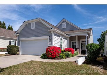 Charming home with gray shingle siding, a two-car garage, and vibrant red landscaping at 3040 Azalea Dr, Indian Land, SC 29707