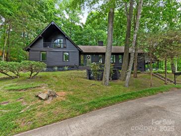 Charming black two-story home with landscaped yard and mature trees at 3232 Johnny Cake Ln, Charlotte, NC 28226