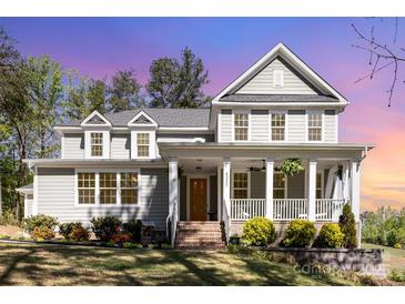 Charming two-story home with a large front porch and landscaped yard at 4237 Island Fox Ln, Denver, NC 28037
