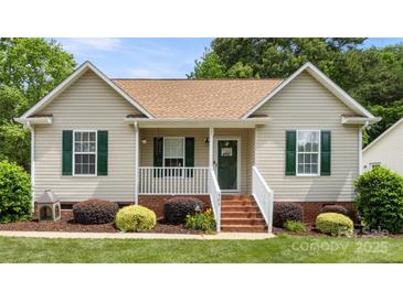 Charming single-story home featuring green shutters, a covered porch, and well-manicured landscaping at 505 Tea Olive Ct, Rock Hill, SC 29732