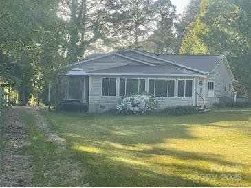 Charming single-story home featuring a well-manicured front yard and inviting screened-in porch at 814 Columbia Dr, Chester, SC 29706