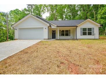 Charming single-story home with white siding, gray shutters, attached garage, and newly seeded front lawn at 164 Hillndale Ln, Statesville, NC 28677