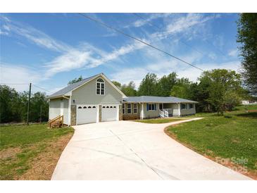 Charming home featuring an attached two-car garage, complemented by a well-manicured lawn and a long driveway at 2019 Kingston Rd, Kingstown, NC 28150