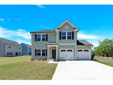Charming two-story home features a two-car garage, well-maintained lawn, and welcoming curb appeal at 207 Aspire Cir # 46, Wingate, NC 28174