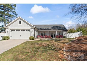Charming single-story home with a two-car garage, covered porch, and well-maintained lawn and landscape at 247 Timberland Loop, Mooresville, NC 28115