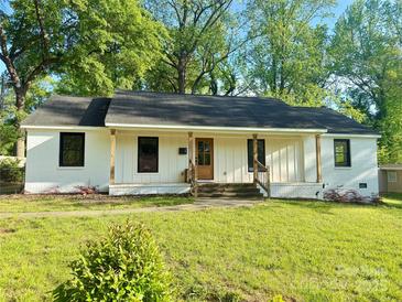 Charming exterior of a one-story home featuring a well-kept lawn and a cozy front porch with wooden columns at 3317 Sargeant Dr, Charlotte, NC 28217