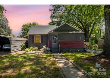 Charming single-story home featuring a screened-in porch, cozy curb appeal and sidewalk leading up to the front door at 3919 Sarah Dr # 14, Charlotte, NC 28217