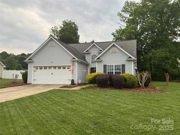 Charming single-Gathering home features a lush front yard with manicured lawn, complemented by mature trees at 503 Azure Ave, Albemarle, NC 28001