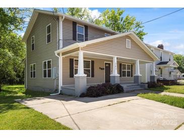 Charming two-story home with a inviting front porch, complemented by a well-maintained lawn and concrete driveway at 543 Hampton St, Rock Hill, SC 29730