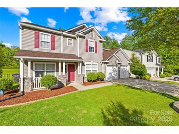 Charming two-story home with red shutters, manicured lawn, and a two-car garage in a desirable neighborhood at 6222 Ohaus Ct # 59, Charlotte, NC 28216