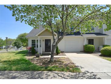 Charming townhome featuring a well-maintained yard and an attached one car garage at 6631 Vlosi Dr, Charlotte, NC 28226