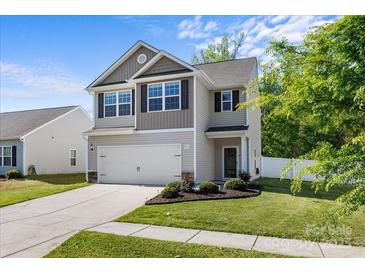 Attractive exterior view of a well-maintained two-story home showcasing a manicured lawn and attached two-car garage at 7113 Amberly Hills Rd, Charlotte, NC 28215