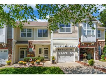 Inviting townhome featuring a one car garage, tidy landscaping, and a charming stone facade at 749 Petersburg Dr, Fort Mill, SC 29708