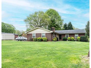 Charming single-story home with a well-manicured lawn and mature landscaping adding to its curb appeal at 1025 Hefner Nw Dr, Conover, NC 28613