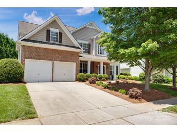 Charming two-story home featuring a brick and siding exterior, complemented by a well-manicured front yard and a two-car garage at 105 Runningdeer Dr, Mooresville, NC 28117