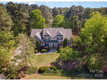 Beautiful home featuring a manicured lawn and mature trees offering shade and privacy at 108 Bare Foot Ln, Mooresville, NC 28117