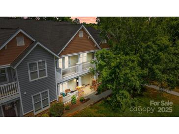 Inviting townhome boasts charming balconies and covered entryway at 11139 Dundarrach Ln, Charlotte, NC 28277