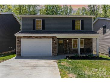 Charming two-story home with stone accents, a welcoming front porch, and a well-manicured lawn at 1336 26Th Ne Ave, Hickory, NC 28601