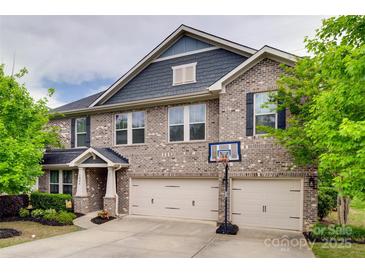 Beautiful two-story brick home with a two-car garage and well-maintained landscaping at 1446 Cilantro Ct, Tega Cay, SC 29708