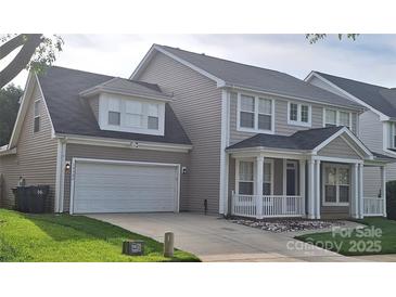 Charming two-story home featuring a two-car garage, inviting front porch, and well-maintained landscaping at 15326 Carrington Ridge Dr, Huntersville, NC 28078