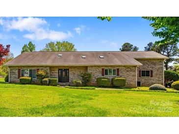 Charming ranch-style brick home with manicured lawn and mature landscaping at 189 Billy Jo Rd, Mooresville, NC 28117