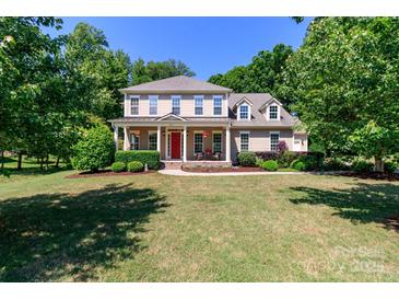 Charming two-story home with a landscaped front yard, inviting porch, and classic architectural details at 2153 Darian Way, Waxhaw, NC 28173