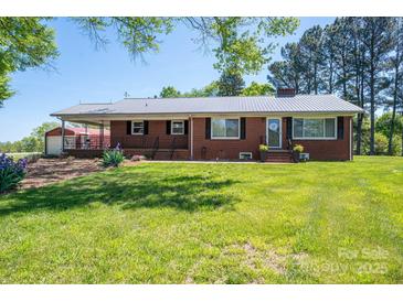 Charming brick home with a well-maintained lawn and inviting front porch at 3340 Wrenwood Dr, Newton, NC 28658