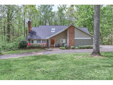 Charming home featuring brick chimney, mature trees, and well-maintained lawn at 512 Saint Cloud Dr, Statesville, NC 28625